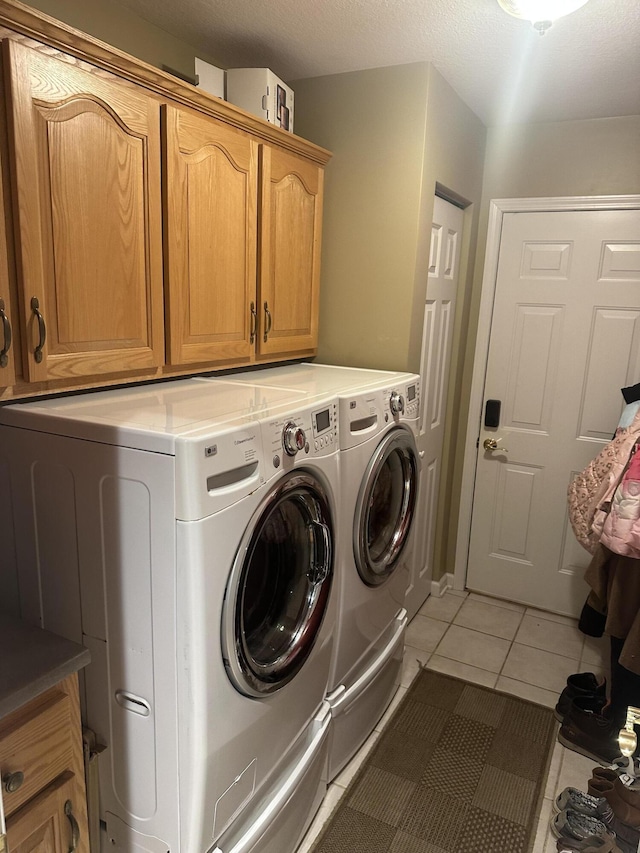 133 Bingham Dr, Brooklyn, MI 49230 - clothes washing area featuring cabinet space, independent washer and dryer, and light tile patterned flooring