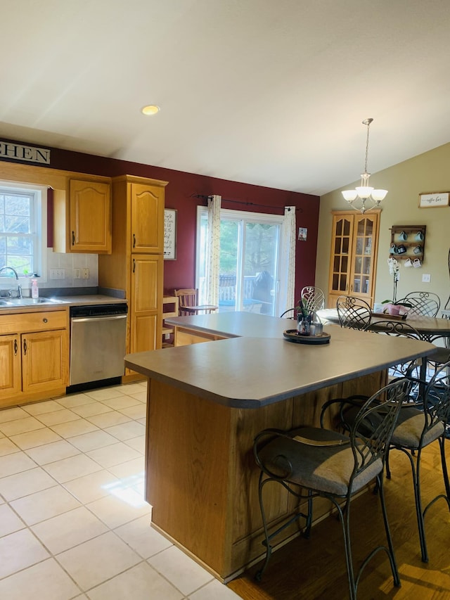 133 Bingham Dr, Brooklyn, MI 49230 - kitchen featuring stainless steel dishwasher, a sink, a breakfast bar area, lofted ceiling, and a chandelier