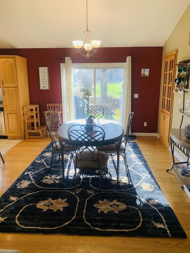 133 Bingham Dr, Brooklyn, MI 49230 - dining area with a chandelier, vaulted ceiling, and light wood-type flooring