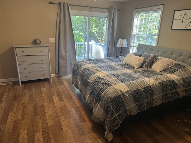 133 Bingham Dr, Brooklyn, MI 49230 - bedroom featuring access to outside, wood finished floors, multiple windows, and baseboards