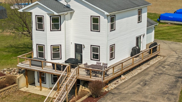 14204 Northmoor Dr, Cement City, MI 49233 - rear view of house with a shingled roof, driveway, a deck, and stairs