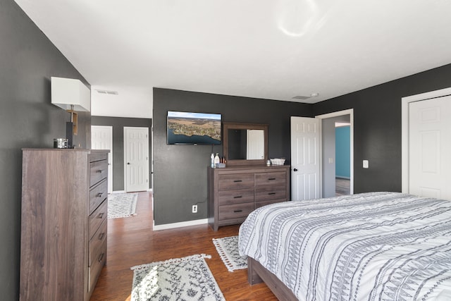 14204 Northmoor Dr, Cement City, MI 49233 - bedroom with dark wood-style flooring, baseboards, and visible vents