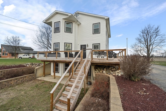 14204 Northmoor Dr, Cement City, MI 49233 - back of property with stairs, a deck, and a lawn