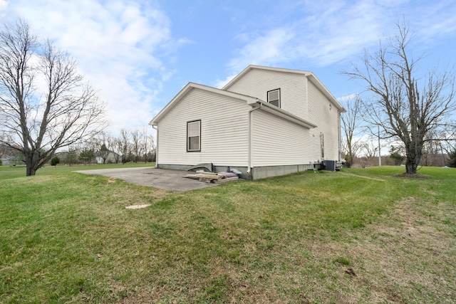14204 Northmoor Dr, Cement City, MI 49233 - view of home's exterior with a patio area, a lawn, and central air condition unit
