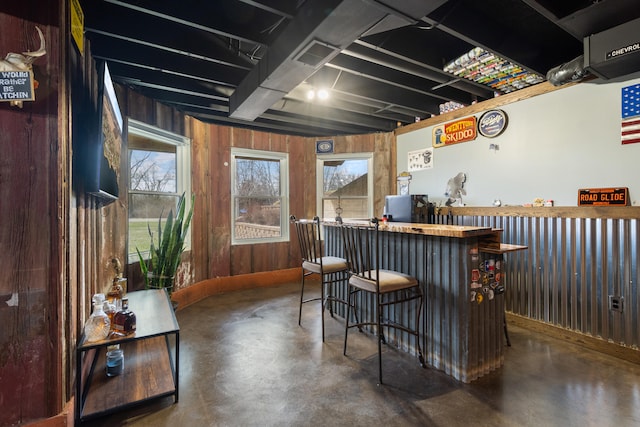 14204 Northmoor Dr, Cement City, MI 49233 - bar featuring concrete floors, wooden walls, and visible vents