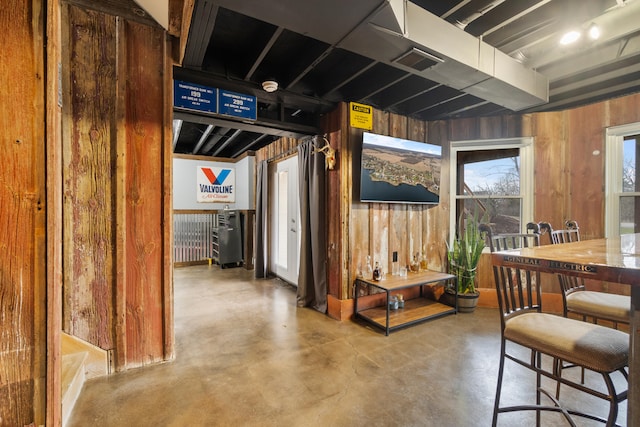 14204 Northmoor Dr, Cement City, MI 49233 - interior space featuring wood walls, concrete floors, and visible vents