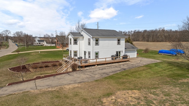 14204 Northmoor Dr, Cement City, MI 49233 - back of house featuring a wooden deck, a shingled roof, and a lawn