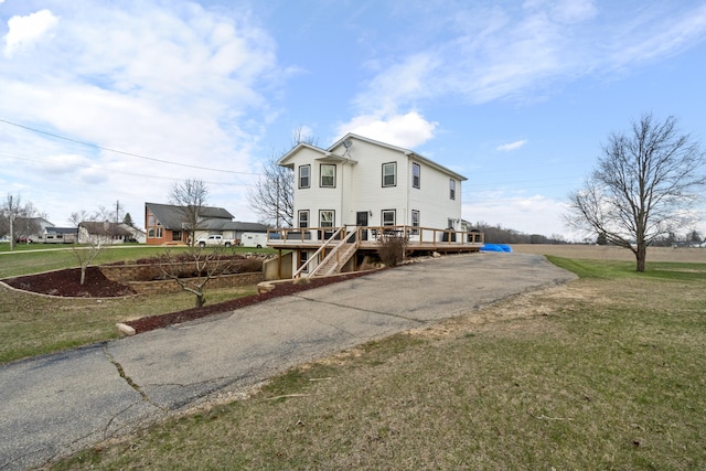 14204 Northmoor Dr, Cement City, MI 49233 - rear view of property with driveway, a deck, and a lawn