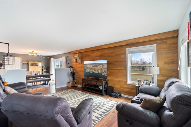 14204 Northmoor Dr, Cement City, MI 49233 - living area featuring wooden walls, baseboards, and wood finished floors