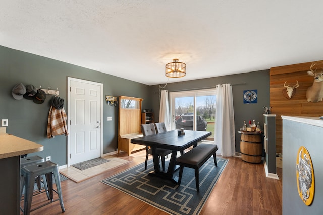14204 Northmoor Dr, Cement City, MI 49233 - dining space featuring a notable chandelier, baseboards, and wood finished floors