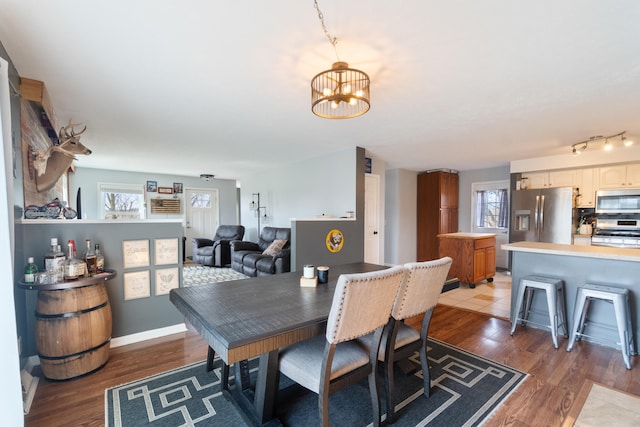 14204 Northmoor Dr, Cement City, MI 49233 - dining room featuring a notable chandelier, baseboards, and light wood-style flooring