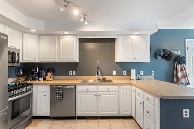 14204 Northmoor Dr, Cement City, MI 49233 - kitchen featuring a sink, white cabinets, a peninsula, and stainless steel appliances