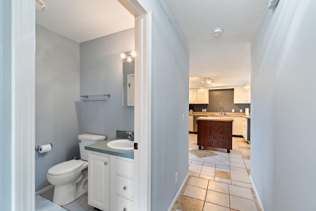 14204 Northmoor Dr, Cement City, MI 49233 - bathroom with tile patterned flooring, vanity, baseboards, and toilet
