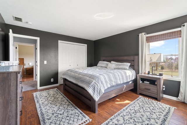 14204 Northmoor Dr, Cement City, MI 49233 - bedroom with visible vents, a closet, baseboards, and wood finished floors