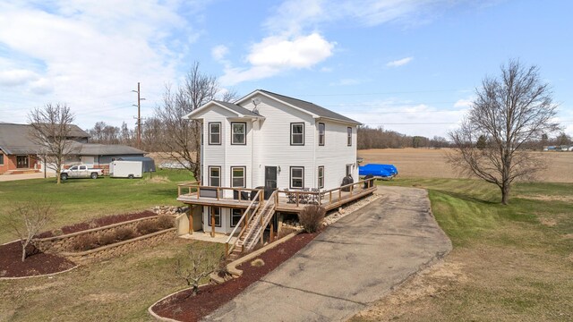 14204 Northmoor Dr, Cement City, MI 49233 - exterior space featuring driveway, a wooden deck, a front lawn, and stairway