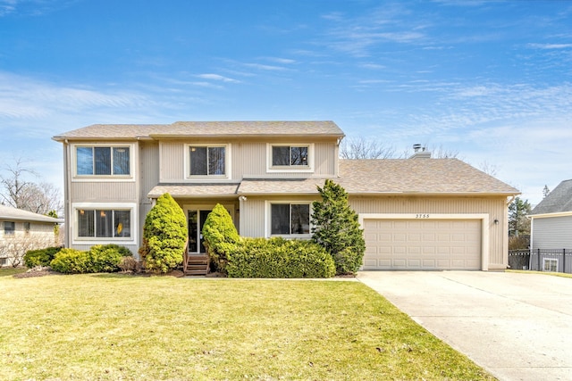 3755 Oak Dr, Ypsilanti, MI 48197 - traditional-style home featuring a chimney, a garage, driveway, and a front lawn