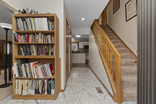 3755 Oak Dr, Ypsilanti, MI 48197 - hall featuring visible vents, baseboards, recessed lighting, stairs, and marble finish floor