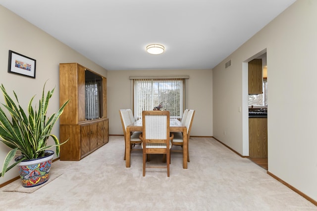 3755 Oak Dr, Ypsilanti, MI 48197 - dining space with light carpet, visible vents, and baseboards