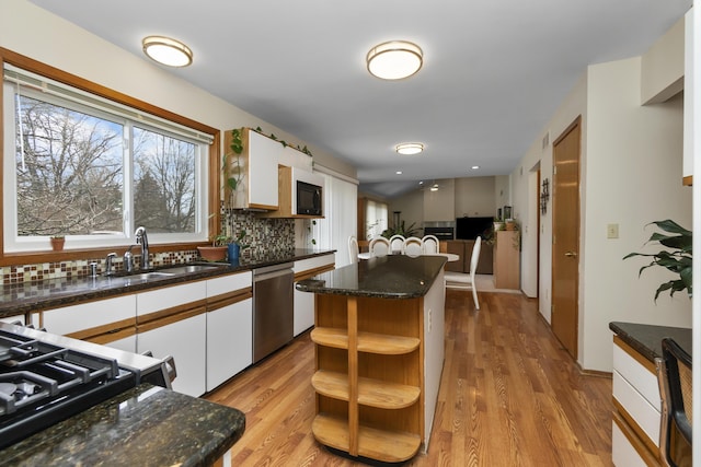 3755 Oak Dr, Ypsilanti, MI 48197 - kitchen featuring stainless steel dishwasher, white cabinets, a sink, and decorative backsplash