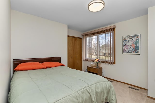 3755 Oak Dr, Ypsilanti, MI 48197 - bedroom with light carpet, a closet, baseboards, and visible vents