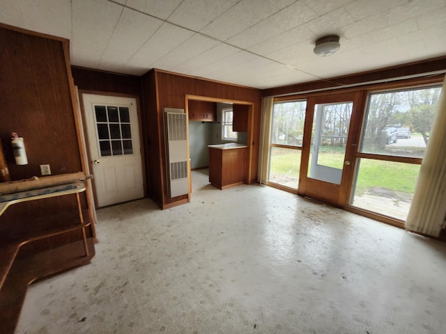 309 N Main St, Scottville, MI 49454 - unfurnished living room with wooden walls and visible vents
