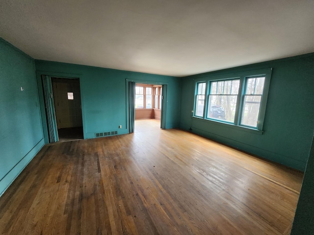 309 N Main St, Scottville, MI 49454 - unfurnished room with wood finished floors, baseboards, and visible vents