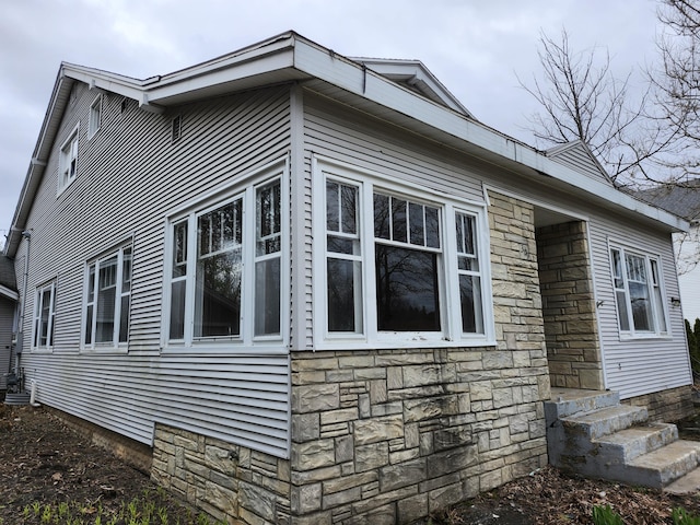 309 N Main St, Scottville, MI 49454 - view of side of home with entry steps and stone siding