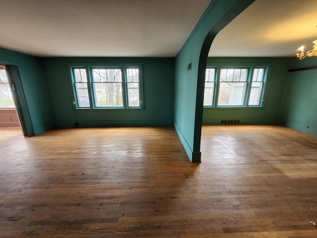 309 N Main St, Scottville, MI 49454 - spare room featuring plenty of natural light, visible vents, and wood finished floors