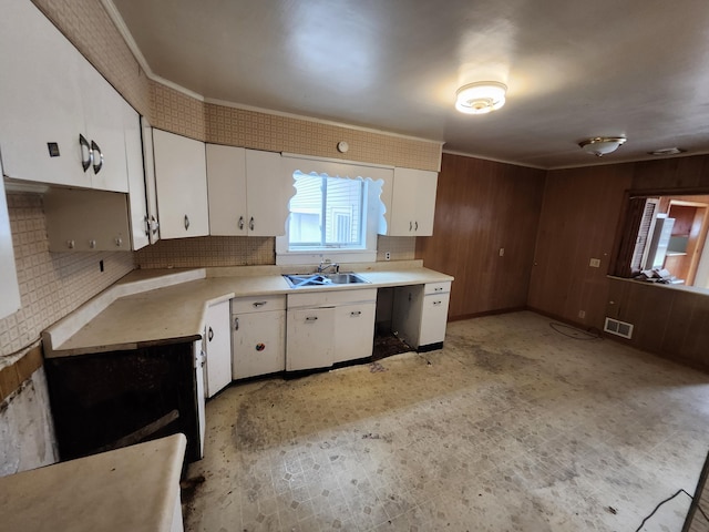 309 N Main St, Scottville, MI 49454 - kitchen with tasteful backsplash, visible vents, a sink, light countertops, and white cabinetry
