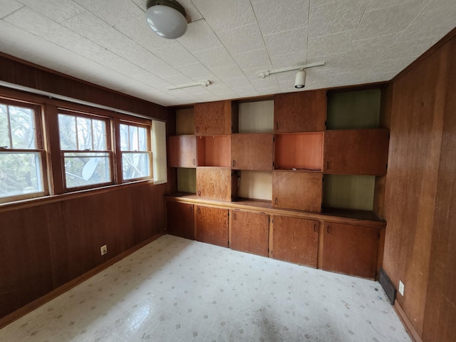 309 N Main St, Scottville, MI 49454 - spare room featuring wood walls and baseboards