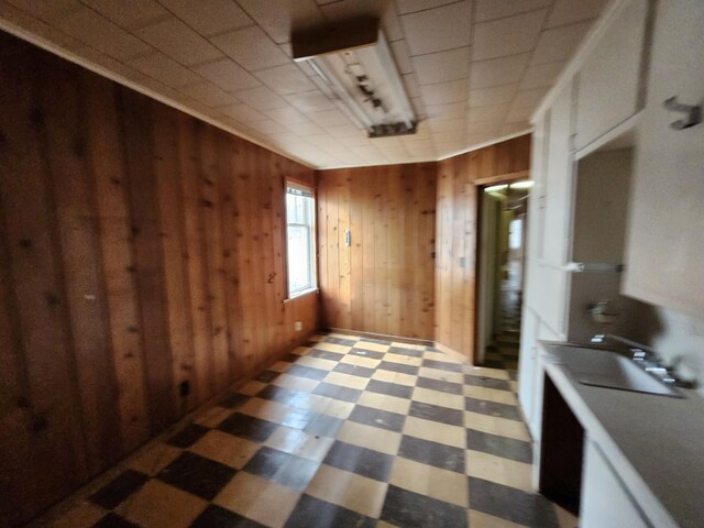 309 N Main St, Scottville, MI 49454 - interior space with tile patterned floors, wooden walls, and a sink