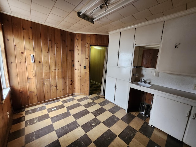 309 N Main St, Scottville, MI 49454 - unfurnished dining area with a sink, light floors, and wooden walls