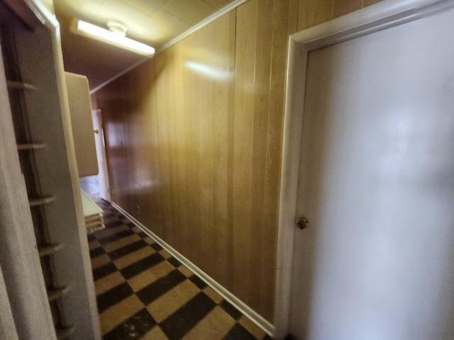 309 N Main St, Scottville, MI 49454 - hallway featuring tile patterned floors, wooden walls, and ornamental molding