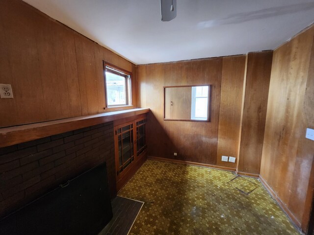 309 N Main St, Scottville, MI 49454 - interior space featuring tile patterned floors, wooden walls, plenty of natural light, and baseboards