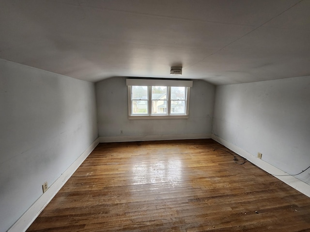 309 N Main St, Scottville, MI 49454 - additional living space with wood finished floors, baseboards, and vaulted ceiling