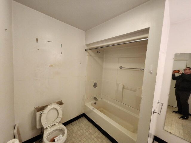 309 N Main St, Scottville, MI 49454 - full bathroom with tile patterned floors, shower / bathtub combination, and toilet
