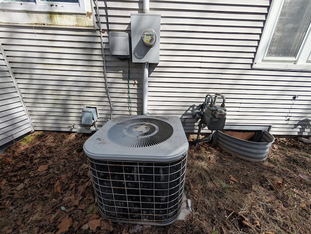 309 N Main St, Scottville, MI 49454 - exterior details featuring electric meter, central AC unit, and gas meter