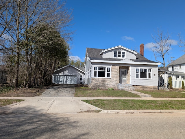 309 N Main St, Scottville, MI 49454 - bungalow-style house with an outbuilding, a garage, and a chimney
