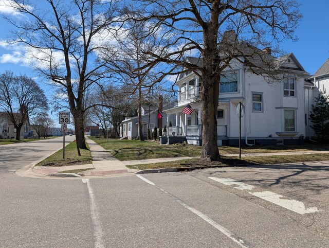 309 N Main St, Scottville, MI 49454 - view of road with sidewalks, a residential view, curbs, and traffic signs