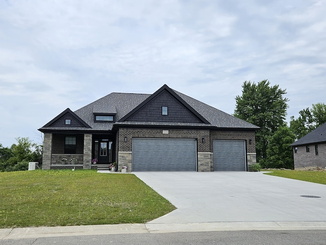 craftsman-style home with driveway, stone siding, an attached garage, a front yard, and central AC