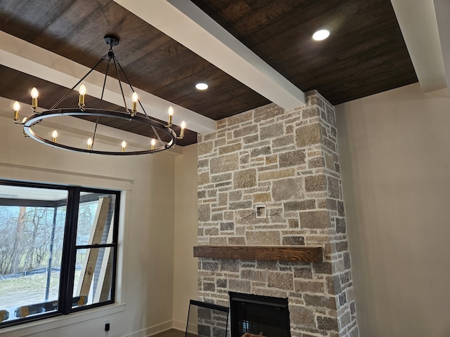 room details featuring baseboards, a chandelier, a fireplace, beam ceiling, and wood ceiling