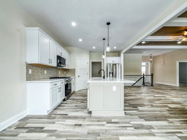 kitchen featuring light wood-style floors, appliances with stainless steel finishes, baseboards, and recessed lighting
