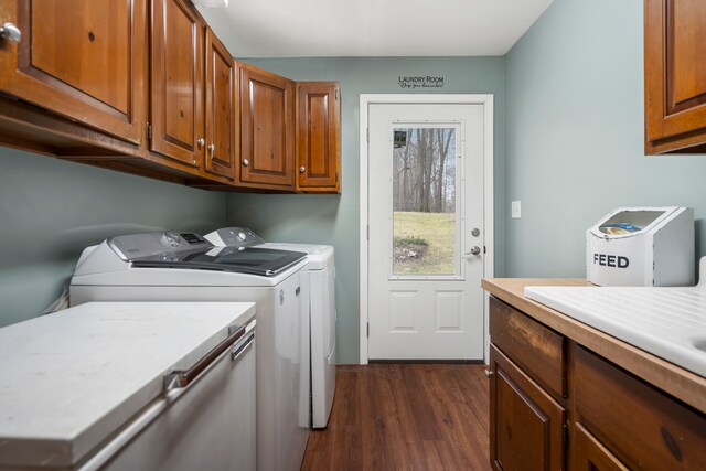 7630 Dilley Rd, Davisburg, MI 48350 - washroom with washing machine and dryer, cabinet space, and dark wood-type flooring