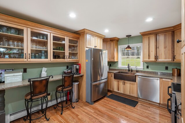 7630 Dilley Rd, Davisburg, MI 48350 - kitchen with appliances with stainless steel finishes, a sink, baseboard heating, glass insert cabinets, and light wood finished floors