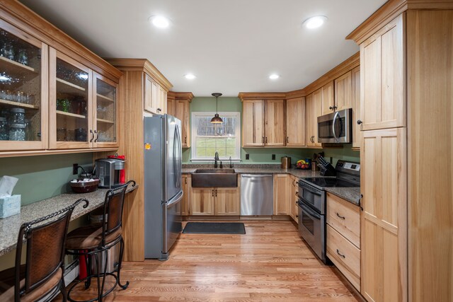 7630 Dilley Rd, Davisburg, MI 48350 - kitchen with appliances with stainless steel finishes, a sink, light brown cabinetry, hanging light fixtures, and glass insert cabinets