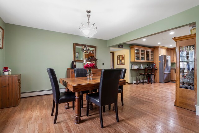 7630 Dilley Rd, Davisburg, MI 48350 - dining area with a baseboard radiator, light wood-style floors, and recessed lighting