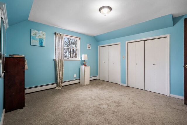 7630 Dilley Rd, Davisburg, MI 48350 - unfurnished bedroom featuring lofted ceiling, multiple closets, carpet floors, baseboard heating, and baseboards
