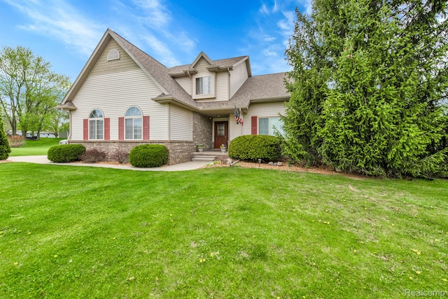 5280 Brantford, Grand Blanc, MI 48439 - traditional home featuring a front yard, a shingled roof, and brick siding