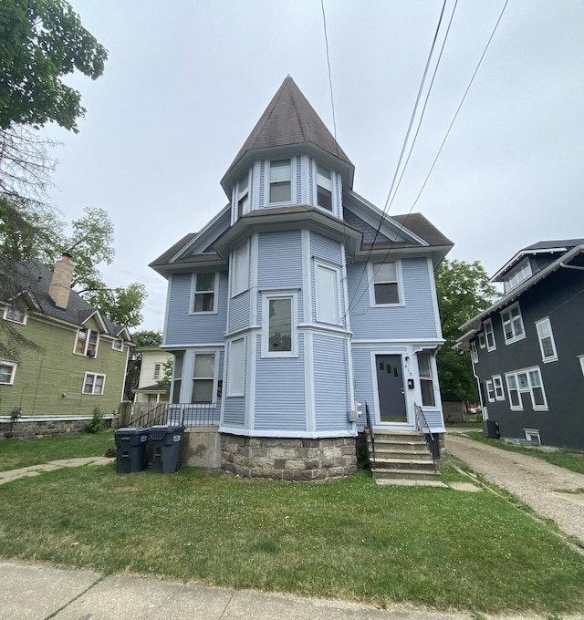 victorian home with a front yard