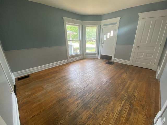 interior space featuring visible vents, baseboards, and hardwood / wood-style floors